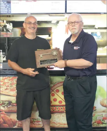  ?? Photo by Larry McGuire/The Punxsutawn­ey Spirit ?? Scott Anthony, owner of Punxsy Pizza, was totally taken by surprise Wednesday when he received the ´.H\ WR WKH &LW\µ IURP 0D\RU 5LFKDUG $OH[DQGHU