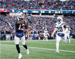  ?? (Reuters) ?? NEW ENGLAND PATRIOTS receiver Phillip Dorsett (left) catches a pass for a touchdown in front of Los Angeles Chargers defender Desmond King (20) during the Patriots’ 41-28 home victory over the Chargers on Sunday night in the teams’ AFC Divisional Round clash.