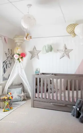  ??  ?? NURSERY
Emily’s adventurer theme features the cotton canvas teepee tent from Decestar, complement­ed by the hot air balloon paper lantern set from Confetti and giraffe head wall sticker from Icon Wall Stickers