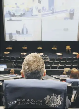  ??  ?? Jurors are spaced throughout the auditorium, at the Odeon cinema complex in Edinburgh, and view the trial live on the big screen, which is split into four portions to show the courtroom, the accused, the judge and witness box.