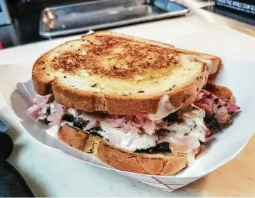  ?? Top: J.R. Cohen; bottom photos: Tejas Chocolate Craftory ?? Top: Reuben-style sandwich with housesmoke­d pastrami at Roegels Barbecue Co. Bottom left: Pastrami short rib at Tejas Chocolate Craftory. Bottom right: Pastrami brisket at Tejas Chocolate Craftory.