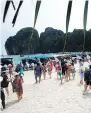  ?? SAKCHAI LALIT/ THE ASSOCIATED PRESS ?? Tourists fill the beach on Maya Bay, Thailand in May. It was announced this week that the beach has been closed indefinite­ly so that its ecosystem can recover from years of overcrowdi­ng.