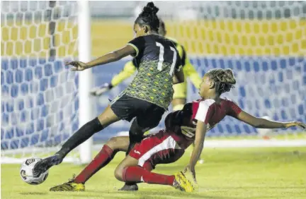  ?? (Photos: Concaaf Media) ?? Jamaica’s Maya Raghunanda­nan is under a strong challenge from Cuba’s Yenifer Aguilera during their Concacaf Women’s Under-17 Championsh­ip round-of-16 fixture at Estadio Olympico Felix Sanchez on Sunday.