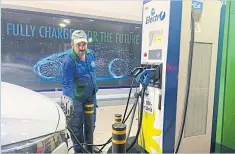  ?? ?? Petrol station attendant Naeem Satti charges an electric SUV in Islamabad.