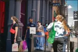  ?? ASSOCIATED PRESS FILE ?? Customers wait in a line before entering a store on Broadway while wearing protective masks in the retail shopping district of the SoHo neighborho­od of the Manhattan borough of New York, Friday, May 14.