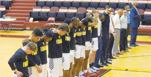  ?? GREG WOHLFORD/ERIE TIMES-NEWS ?? The Gannon University men’s basketball team gathers for the playing of “Lift Every Voice and Sing” immediatel­y following “The Star-Spangled Banner,” prior to a game with Kentucky State last month at the Hammermill Center in Erie, Pa.