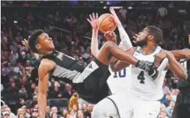  ?? Frank Franklin II, The Associated Press ?? Villanova’s Eric Paschall, right, blocks Providence’s Rodney Bullock’s shot during the Big East Tournament final Saturday.