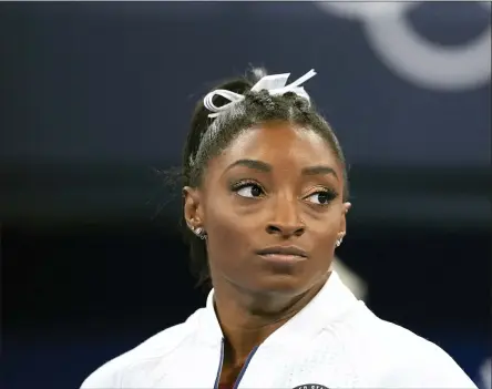  ?? ASHLEY LANDIS — THE ASSOCIATED PRESS ?? Simone Biles, of the United States, watches gymnasts perform after she exited the team final with apparent injury, at the 2020Summer Olympics, Tuesday, July 27, 2021, in Tokyo. The 24-year-old reigning Olympic gymnastics champion Biles huddled with a trainer after landing her vault. She then exited the competitio­n floor with the team doctor.