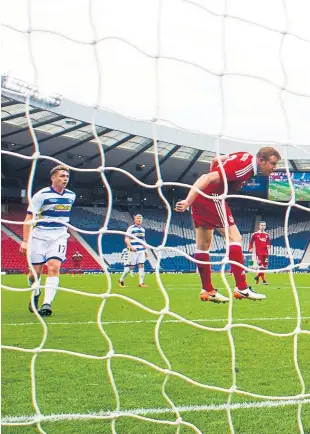  ??  ?? Aberdeen striker Adam Rooney nods home his side’s opener as a spirited Morton side succumbed to a 2-0 defeat at Hampden