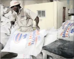 ?? PHOTO: REUTERS ?? A worker lifts a bag of flour at the Dangote Flour Mills in Nigeria, in this file picture. The company failed to make a profit under the control of Tiger Brands, which subsequent­ly sold it back to Aliko Dangote. The author says that there are many...