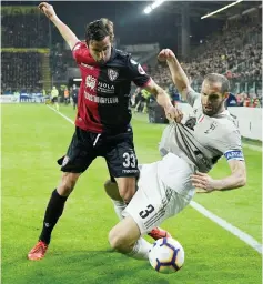  ??  ?? Juventus’ Giorgio Chiellini (right) in action with Cagliari’s Darijo Srna during the Serie A match at Sardegna Arena, Cagliari in Italy in this April 2 file Photo. — Reuters photo