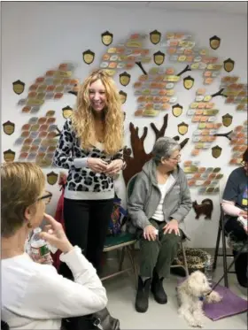  ?? JOEL KAPLAN — RACHEL GELLER VIA AP ?? In this undated photo, Rachel Geller talks with volunteers who have gathered to learn more about cat behavior near Boston. Geller works as a “cat whisperer” and leads seminars and gives talks to many Boston-area animal welfare organizati­ons.