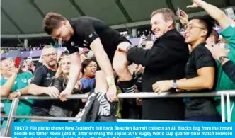  ??  ?? TOKYO: File photo shows New Zealand’s full back Beauden Barrett collects an All Blacks flag from the crowd beside his father Kevin (2nd R) after winning the Japan 2019 Rugby World Cup quarter-final match between New Zealand and Ireland at the Tokyo Stadium in Tokyo. — AFP