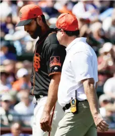  ?? | CHRIS CARLSON/ AP ?? Giants left- hander MadisonBum­garner leaves the field after getting hit by a batted ball in the third inning Friday against the Royals.