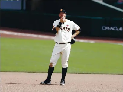  ?? PHOTOS BY NHAT V. MEYER — BAY AREA NEWS GROUP FILE ?? The San Francisco Giants’ Brandon Belt stands at first base after the Oakland Athletics’ Marcus Semien (10) hits a two-run home run in the fifth inning at Oracle Park in San Francisco on Aug. 16, 2020.