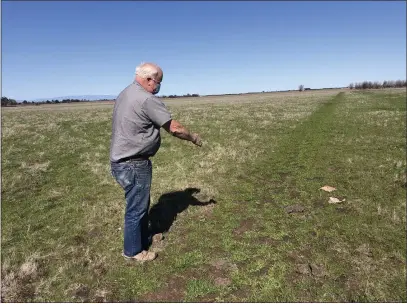  ?? NATALIE HANSON — ENTERPRISE-RECORD ?? Former Butte County supervisor Ed McLaughlin shows the property line Thursday where he and Barbara Weibel own land near the Chico Airport in Chico, which they offered to the city in fall 2020 for a sanctioned campground. The city has not shown interest since then, they said.