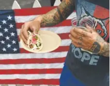  ?? RJ Sangosti, Demver Post file ?? Johnny Corpus eats a taco at Chuey Fu’s booth during the Taste of Colorado in downtown Denver on Sept. 2, 2016.