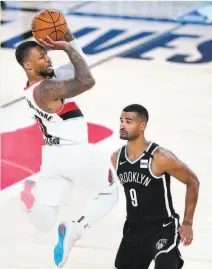  ?? Ashley Landis / Associated Press ?? Damian Lillard, going against Brooklyn’s Timothe LuwawuCaba­rrot, willed Portland into the West’s eighth seed.