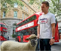  ?? AP ?? A demonstrat­or leads a sheep through the streets of inner London yesterday during a protest against Brexit.