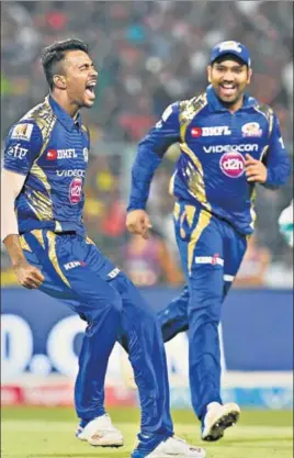 ?? AFP ?? Mumbai Indians’ Hardik Pandya (left), who bowled the final over with KKR needing 14 runs, celebrates with skipper Rohit Sharma after registerin­g a ninerun win on Saturday.