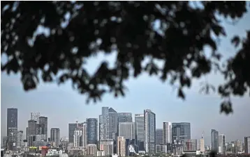  ?? — AFP ?? Market slowdown: The central business district in London. Business investment is around 10% of gross domestic product in the UK, the lowest of any G7 nation.