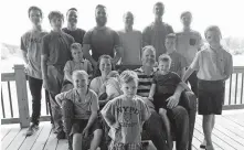  ?? HOUSEHOLDE­R, FILE] ?? In this May 30, 2018, file photo, the Schwandt family poses for a photo at their farm in Lakeview, Mich. Standing from left are Tommy, Calvin, Drew, Tyler, Zach, Brandon, Gabe, Vinny and Wesley. Seated, starting at upper left are Charlie, Luke, mother Kateri holding Finley, father Jay with Tucker and Francisco in the foreground. [AP PHOTO/MIKE