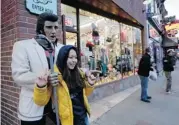  ??  ?? Kim Young, of Seoul, South Korea, gets a photo by a statue of Elvis Presley on Broadway in Nashville.