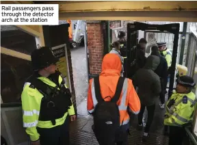  ?? ?? Rail passengers pass through the detector arch at the station