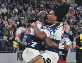  ?? PHOTOSPORT ?? Mark Tele’a of the Blues celebrates his try early in the second half as the home team held on to beat the Hurricanes at Eden Park and claim the top of the Super Rugby Pacific table last night.