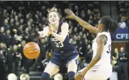  ?? Reinhold Matay / Associated Press ?? Katie Lou Samuelson passes against UCF on Sunday.