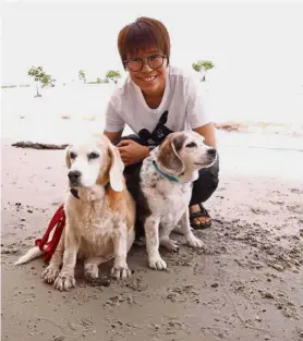  ??  ?? Lucky to be alive: Lau and her dogs Kiki (left) and JoJo had a close brush with death after a visit to the Sungai Pisang waterfall in Gombak.