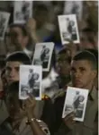  ??  ?? Military cadets hold pictures of Fidel Castro in Revolution Square in Havana on Tuesday night.