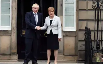  ??  ?? Scotland’s First Minister Nicola Sturgeon (right) shakes hands with Britain’s Prime Minister Boris Johnson, outside Bute House, ahead of their meeting, in Edinburgh, Scotland, on Monday. JAne BArlow/PA VIA AP