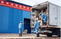  ?? ?? Workers at Huawen Food (Kenya) Ltd. load boxes laden with anchovies in readiness for export to China