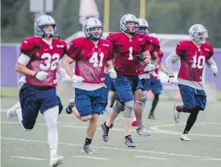  ?? DARIO AYALA/MONTREAL GAZETTE FILES ?? Nicholas Shortill, third from left, takes part in the Montreal Alouettes training camp at Bishop’s University in Lennoxvill­e in May.