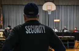  ?? Kylie Cooper, AFP via Getty Images ?? A security guard observes a Pennsbury School Board meeting in Levittown, Pa., on Dec. 16, 2021. In a shift mirrored in cities across America, school boards unwittingl­y have become a battlegrou­nd in the politicize­d culture wars roiling the nation.