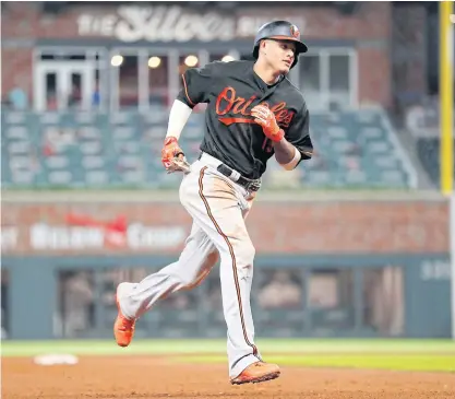  ??  ?? Orioles shortstop Manny Machado rounds the base after hitting a two-run home run in the 15th inning.