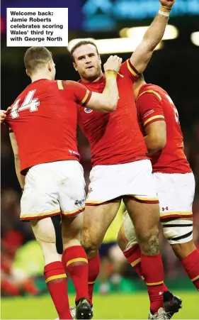  ??  ?? Welcome back: Jamie Roberts celebrates scoring Wales’ third try with George North