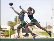  ?? ASHLEY LANDIS — THE ASSOCIATED PRESS FILE ?? Syndel Murillo, 16, left, and Shale Harris, 15, reach for a pass as they try out for the Redondo Union High School girls flag football team on Sept. 1, 2022, in Redondo Beach.