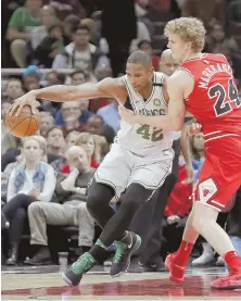  ?? AP PHOTO ?? PUSH IT: Al Horford backs toward the basket against Lauri Markkanen during last night’s game in Chicago.