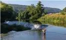  ??  ?? A swimmer standing in the shallows of the River Avon at Warleigh Weir in Somerset, England. Photograph: Anthony Brown/ Alamy