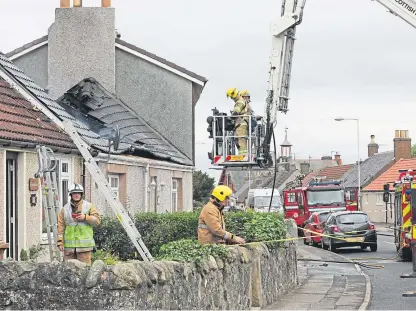  ?? Picture: Gareth Jennings. ?? Firefighte­rs mop up after the blaze broke out in a bungalow on Main Street in Coaltown of Balgonie.