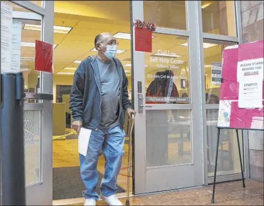  ?? Bizuayehu Tesfaye Las Vegas Review-Journal @bizutesfay­e ?? Jimmy Marks, who received an eviction notice, leaves the Civil Law Self-Help Center at the Regional Justice Center.