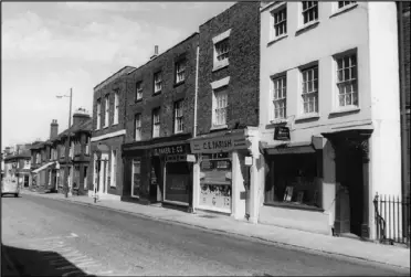  ?? ?? 1963 - A splendid picture depicting the individual­ity the town had in the way of business in bygone years. Here we can see C.Baker wholesale confection­er in North Street, together with C.E. Parish groceries and provisions and R&I Dancey, the 'invisible tailor'