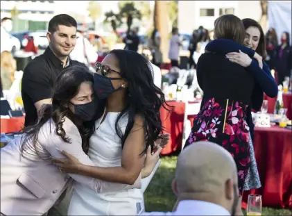  ??  ?? ABOVE: UNLV School of Medicine graduates Ginger Christian, left, and Lauren Hollifield react after opening an envelope that told them where they’ll be for their residency. Hollifield was matched with the University of Pennsylvan­ia and Christian with UNLV OB/GYN.