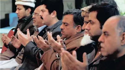  ?? | Reuters ?? RELATIVES of Naeem Rashid, who was killed along with his son, Talha Naeem, in the Christchur­ch mosque attack in New Zealand, pray during a condolence gathering at the family’s home in Abbottabad, Pakistan, yesterday.