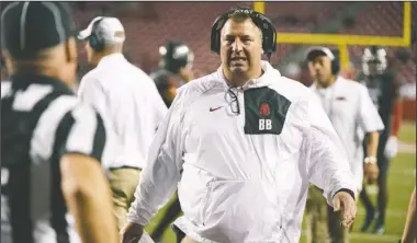  ?? The Associated Press ?? FUTURE UNCERTAIN: Arkansas coach Bret Bielema, center, talks to an official during the second half of Saturday’s against Auburn in Fayettevil­le.