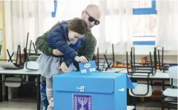  ?? (Flash90) ?? PEOPLE CAST their ballot at a voting station in Tel Aviv during the Knesset election on March 2, 2020.