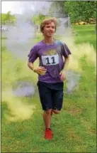  ?? DIGITAL FIRST MEDIA FILE PHOTO ?? A student emerges from a cloud of during a color run fundraiser at West-Mont Christian Academy in North Coventry. The Reading Symphony Orchestra is hosting the event which includes a 10K, 5K and 1-mile fun run. The free 60-minute concert by the...