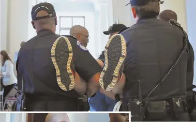  ?? AP PHOTOS ?? CRITICAL: Capitol police carry protesters away from a health care-focused sit-in outside Senate Majority Leader Mitch McConnell’s office yesterday.